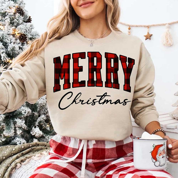 May include a close view of the words “Merry Christmas” printed on fabric, with the top word in a red and black buffalo plaid pattern and the script below in clean black lettering.