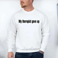 May include a crew neck sweatshirt with the humorous phrase “My Therapist Gave Up” printed on the front.