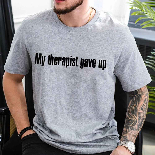 May include a unisex T-shirt with the text “My Therapist Gave Up” printed in a simple, bold style on the front.