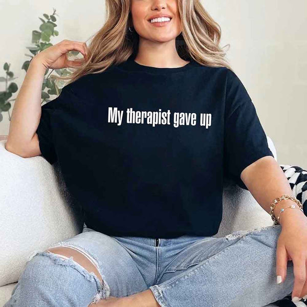 May include a unisex T-shirt with the text “My Therapist Gave Up” printed in a simple, bold style on the front.
