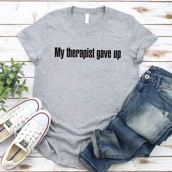 May include a unisex T-shirt with the text “My Therapist Gave Up” printed in a simple, bold style on the front.