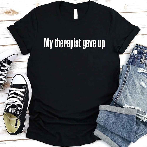 May include a unisex T-shirt with the text “My Therapist Gave Up” printed in a simple, bold style on the front.