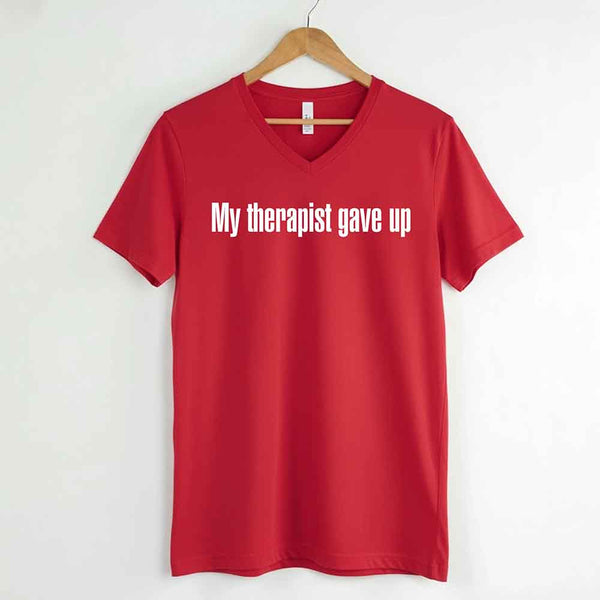 May include a V-neck T-shirt with the humorous phrase “My Therapist Gave Up” displayed on the front.