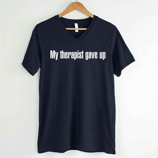 May include a V-neck T-shirt with the humorous phrase “My Therapist Gave Up” displayed on the front.