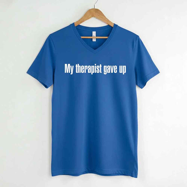 May include a V-neck T-shirt with the humorous phrase “My Therapist Gave Up” displayed on the front.