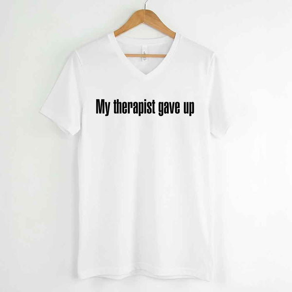 May include a V-neck T-shirt with the humorous phrase “My Therapist Gave Up” displayed on the front.