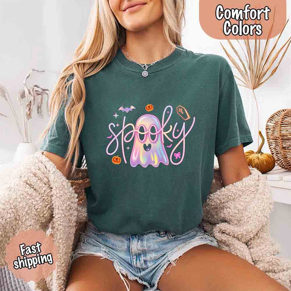 May include holographic ghost with happy face, pastel neon spooky text, pumpkins, bats, coffin, bow, and stars – trendy Halloween graphic tee design.