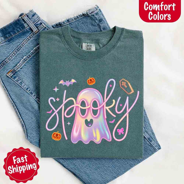 May include holographic ghost with happy face, pastel neon spooky text, pumpkins, bats, coffin, bow, and stars – trendy Halloween graphic tee design.