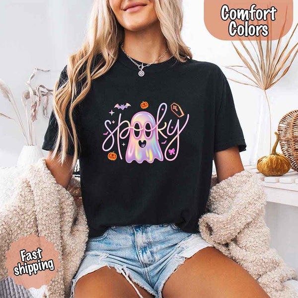May include holographic ghost with happy face, pastel neon spooky text, pumpkins, bats, coffin, bow, and stars – trendy Halloween graphic tee design.