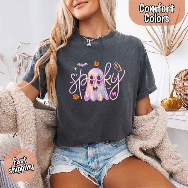May include holographic ghost with happy face, pastel neon spooky text, pumpkins, bats, coffin, bow, and stars – trendy Halloween graphic tee design.