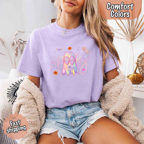 May include holographic ghost with happy face, pastel neon spooky text, pumpkins, bats, coffin, bow, and stars – trendy Halloween graphic tee design.