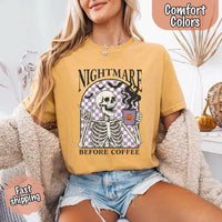 Nightmare Before Coffee skeleton graphic tee featuring skeleton holding a pumpkin coffee mug with steam, bats, and checkered background – funny Halloween coffee shirt.