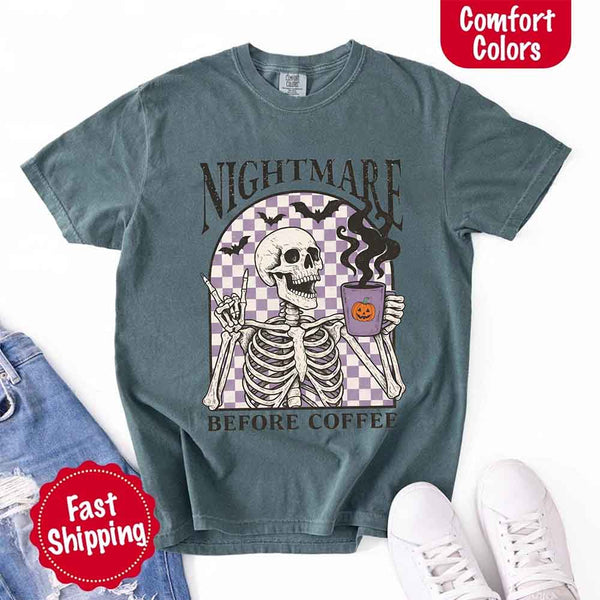 Nightmare Before Coffee skeleton graphic tee featuring skeleton holding a pumpkin coffee mug with steam, bats, and checkered background – funny Halloween coffee shirt.