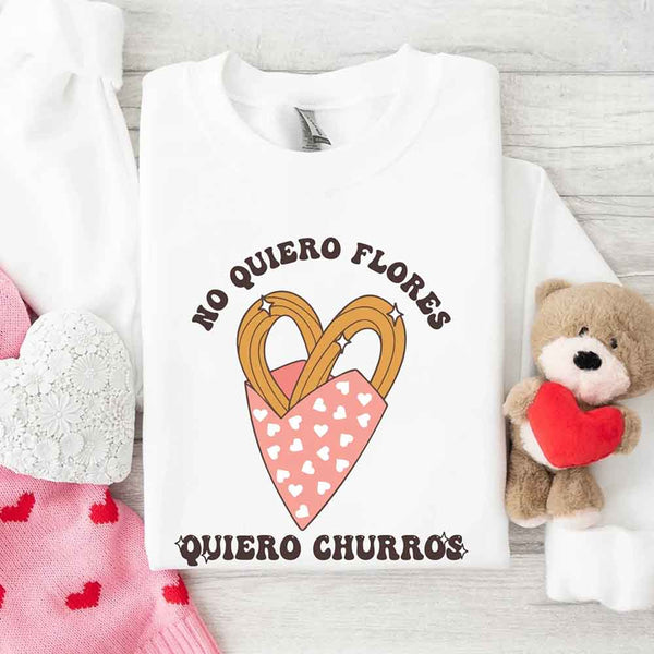 May include a crewneck sweatshirt with a No Quiero Flores Valentine design and a cute churros illustration.