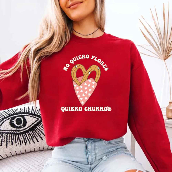 May include a crewneck sweatshirt with a No Quiero Flores Valentine design and a cute churros illustration.