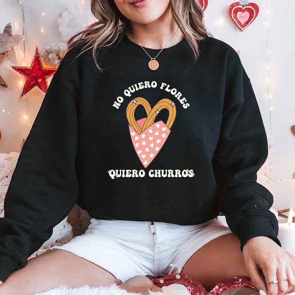 May include a crewneck sweatshirt with a No Quiero Flores Valentine design and a cute churros illustration.
