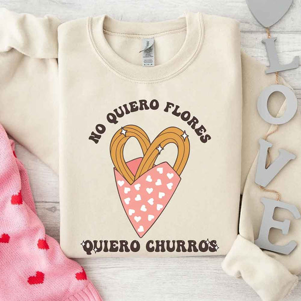 May include a crewneck sweatshirt with a No Quiero Flores Valentine design and a cute churros illustration.
