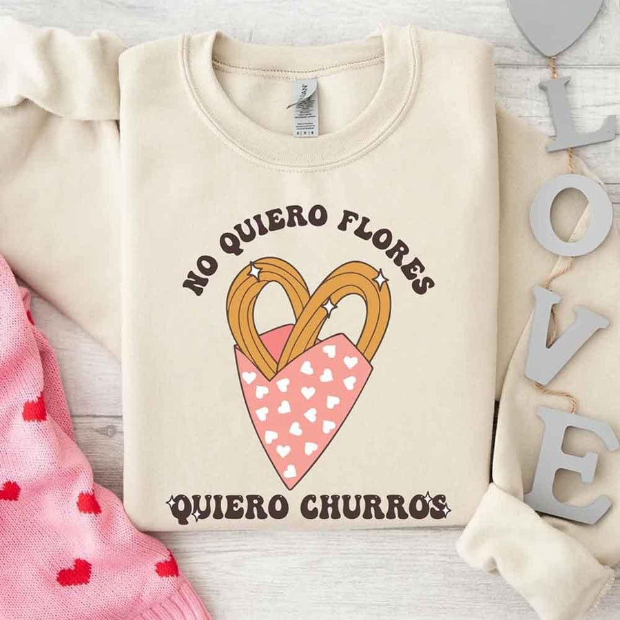 May include a crewneck sweatshirt with a No Quiero Flores Valentine design and a cute churros illustration.