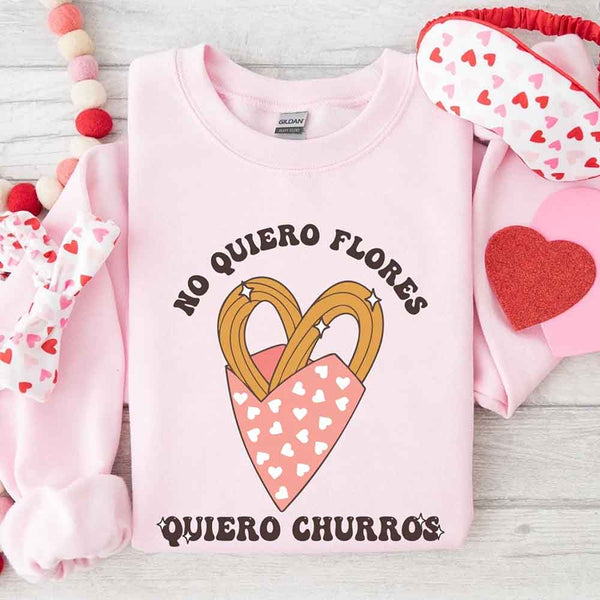 May include a crewneck sweatshirt with a No Quiero Flores Valentine design and a cute churros illustration.