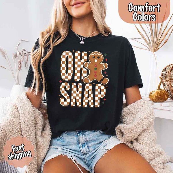 May include a garment-dyed Comfort Colors tee featuring a playful broken gingerbread figure with the phrase “Oh Snap” on the front.