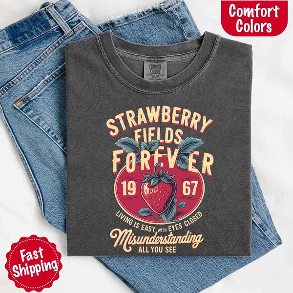 May include vintage-style artwork with a large strawberry and bold text that reads “Strawberry Fields Forever 1967,” along with the phrases “Living is easy with eyes closed” and “Misunderstanding all you see,” inspired by nostalgic and psychedelic themes.