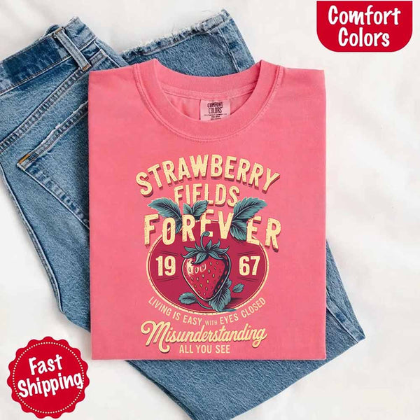 May include vintage-style artwork with a large strawberry and bold text that reads “Strawberry Fields Forever 1967,” along with the phrases “Living is easy with eyes closed” and “Misunderstanding all you see,” inspired by nostalgic and psychedelic themes.