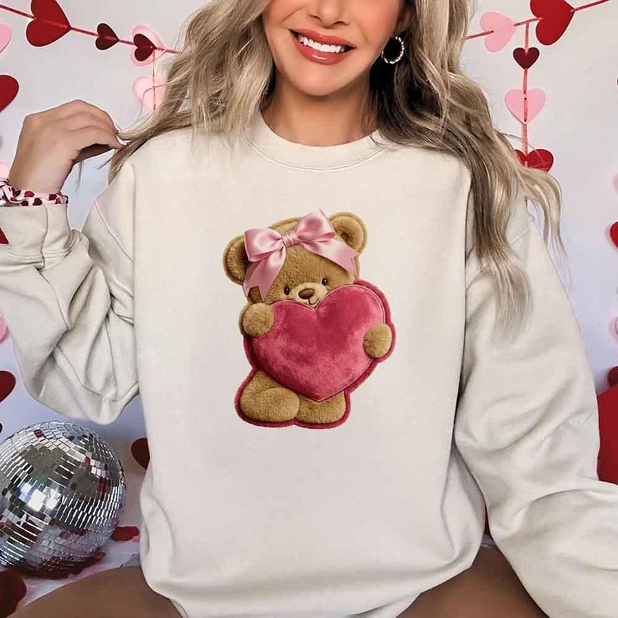 May include a crewneck sweatshirt with a plush teddy Valentine design featuring a furry-look 3D printed effect.