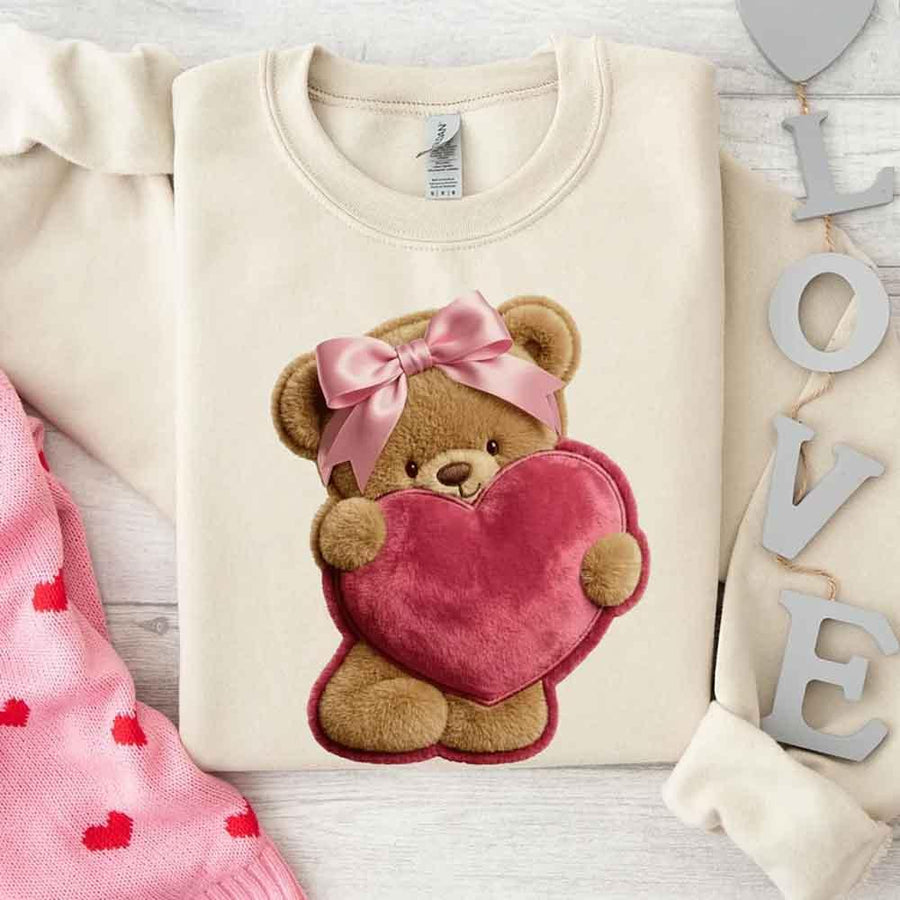 May include a crewneck sweatshirt with a plush teddy Valentine design featuring a furry-look 3D printed effect.