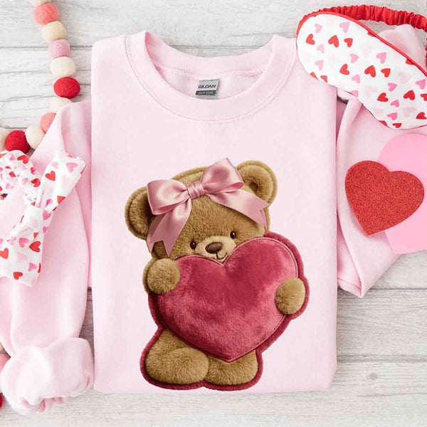 May include a crewneck sweatshirt with a plush teddy Valentine design featuring a furry-look 3D printed effect.