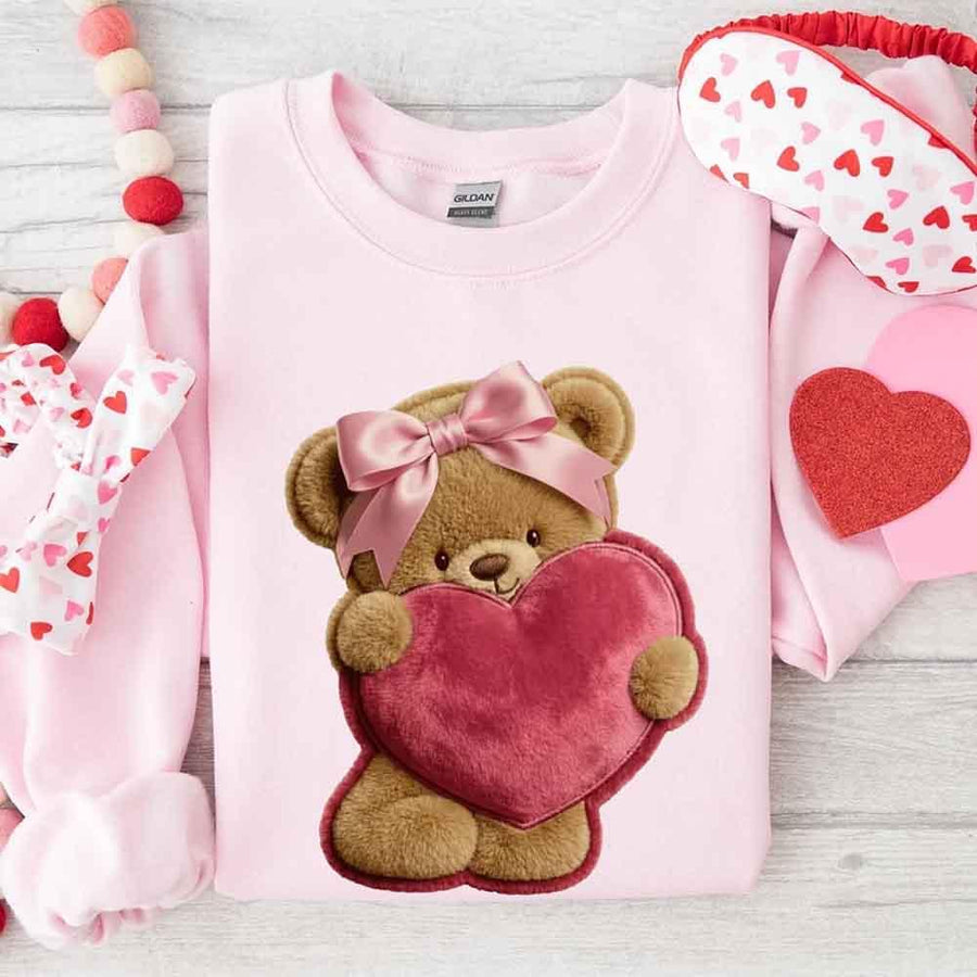 May include a crewneck sweatshirt with a plush teddy Valentine design featuring a furry-look 3D printed effect.