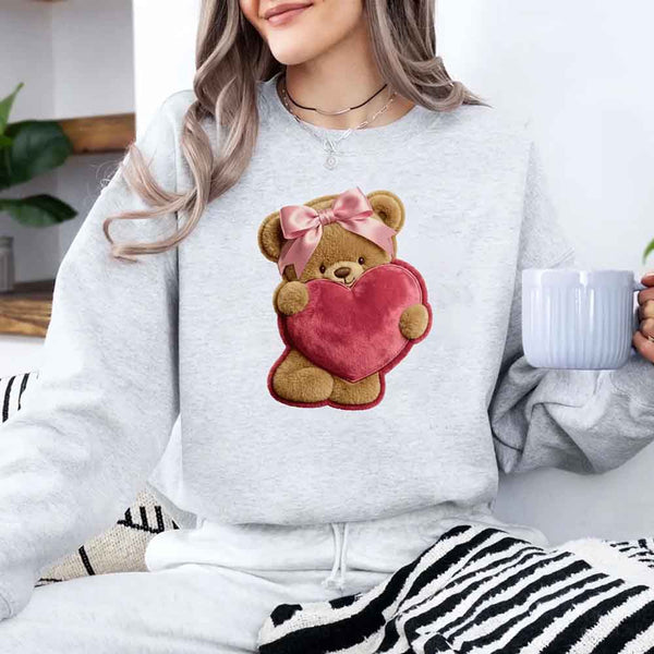 May include a crewneck sweatshirt with a plush teddy Valentine design featuring a furry-look 3D printed effect.