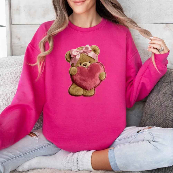 May include a crewneck sweatshirt with a plush teddy Valentine design featuring a furry-look 3D printed effect.