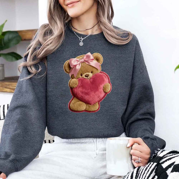 May include a crewneck sweatshirt with a plush teddy Valentine design featuring a furry-look 3D printed effect.