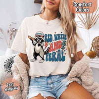 May include a woman wearing a Comfort Colors t-shirt in ivory with a colorful "Red White and Feral" raccoon hotdog print – fun and patriotic summer design.