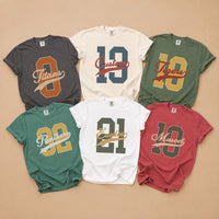 May include a Retro College Football Comfort Colors T-Shirt featuring a vintage-inspired athletic graphic, collegiate lettering, and classic game-day style.