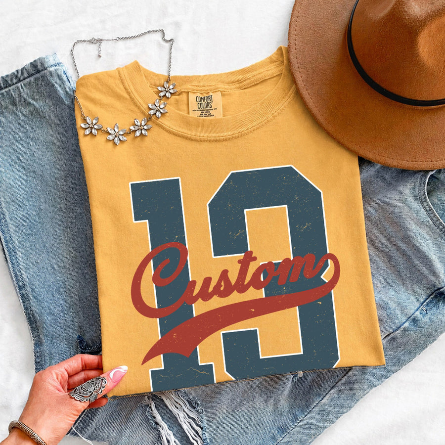 May include a Retro College Football Comfort Colors T-Shirt featuring a vintage-inspired athletic graphic, collegiate lettering, and classic game-day style.