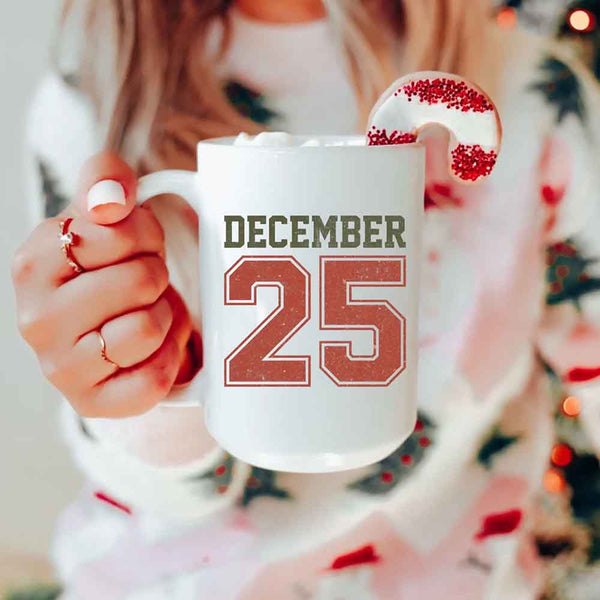 May include a glossy ceramic mug with a retro December 25 Christmas design in traditional holiday colors.