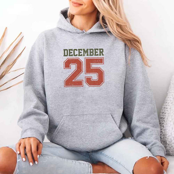 May include a retro-style Christmas hoodie with the text December 25 printed in a clean, vintage-inspired design.