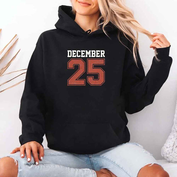 May include a retro-style Christmas hoodie with the text December 25 printed in a clean, vintage-inspired design.