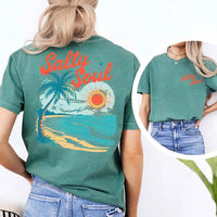 May include a short-sleeve t-shirt with “Salty Soul” printed in bold script on the front left chest and a large back graphic featuring a tropical beach scene with a palm tree, ocean waves, a bright orange sun, and flying birds.