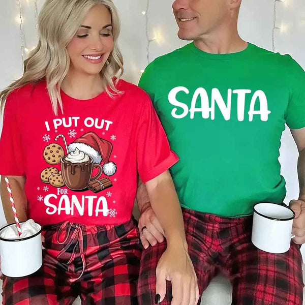 May include a pair of matching Christmas couple shirts with a playful Santa phrase printed on the front, shown on a flat surface.