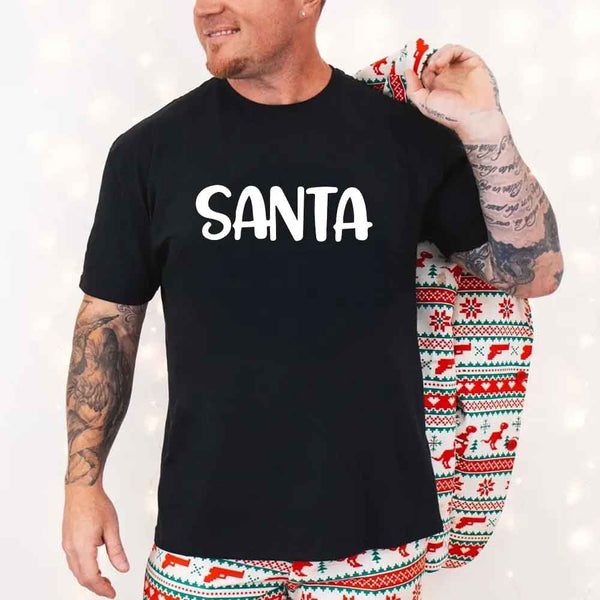 May include a pair of matching Christmas couple shirts with a playful Santa phrase printed on the front, shown on a flat surface.