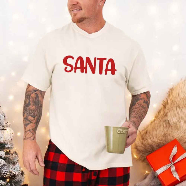 May include a pair of matching Christmas couple shirts with a playful Santa phrase printed on the front, shown on a flat surface.