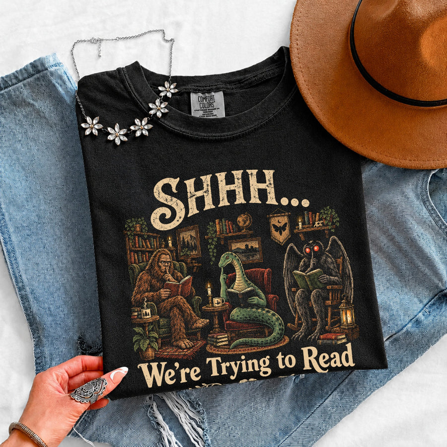 May include a Shhh We're Trying to Read Comfort Colors T-Shirt featuring a playful book lover statement design.