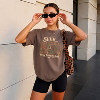 May include a Shhh We're Trying to Read Comfort Colors T-Shirt featuring a playful book lover statement design.