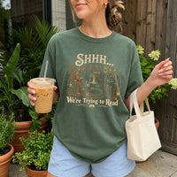 May include a Shhh We're Trying to Read Comfort Colors T-Shirt featuring a playful book lover statement design.