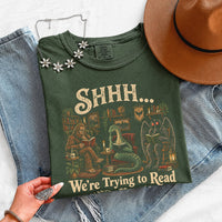 May include a Shhh We're Trying to Read Comfort Colors T-Shirt featuring a playful book lover statement design.