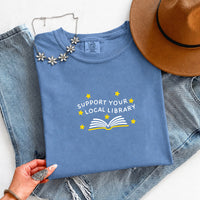 May include a Support Your Local Library Comfort Colors T-Shirt featuring a simple library-inspired statement design.