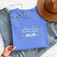 May include a Support Your Local Library Comfort Colors T-Shirt featuring a simple library-inspired statement design.