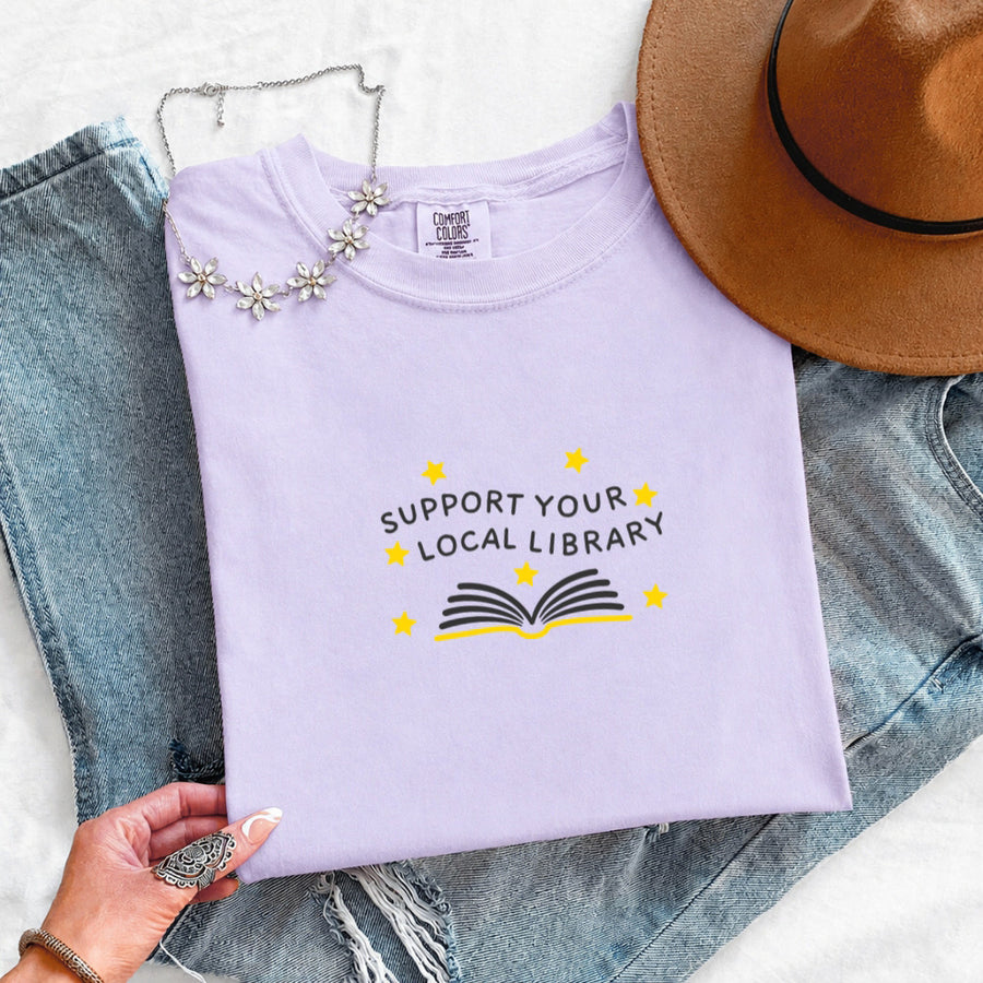 May include a Support Your Local Library Comfort Colors T-Shirt featuring a simple library-inspired statement design.